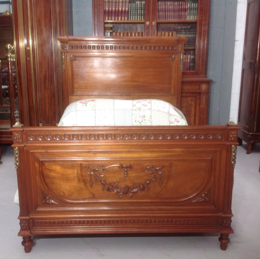 carved walnut french bed with brass detailing