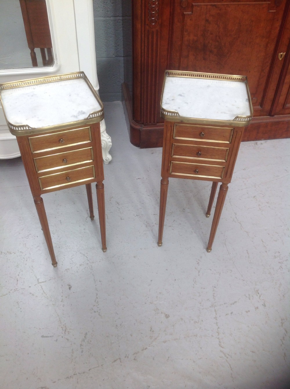 pair of brass and mahogany bedside cabinets