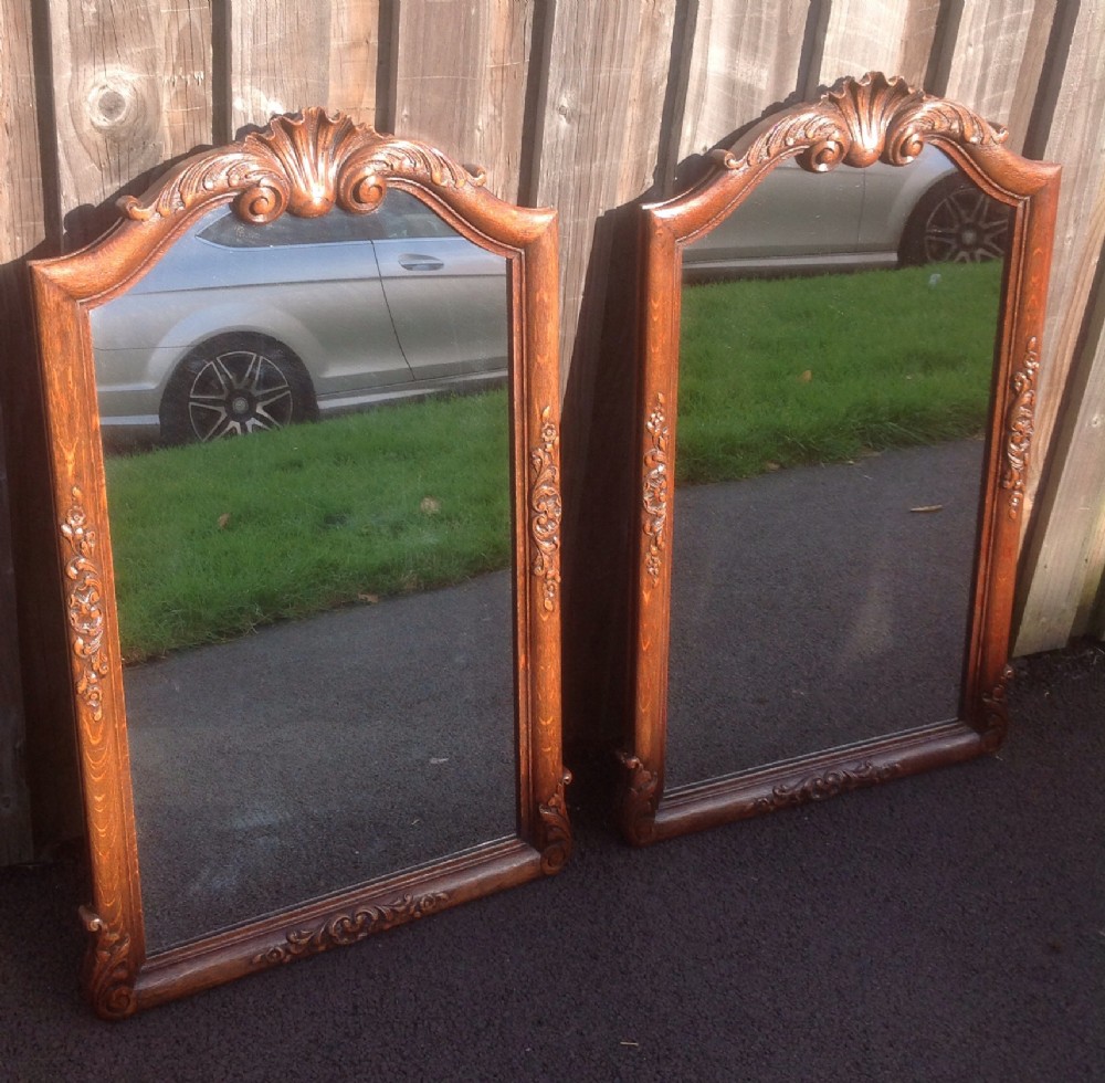 pair of carved oak french wall mirrors
