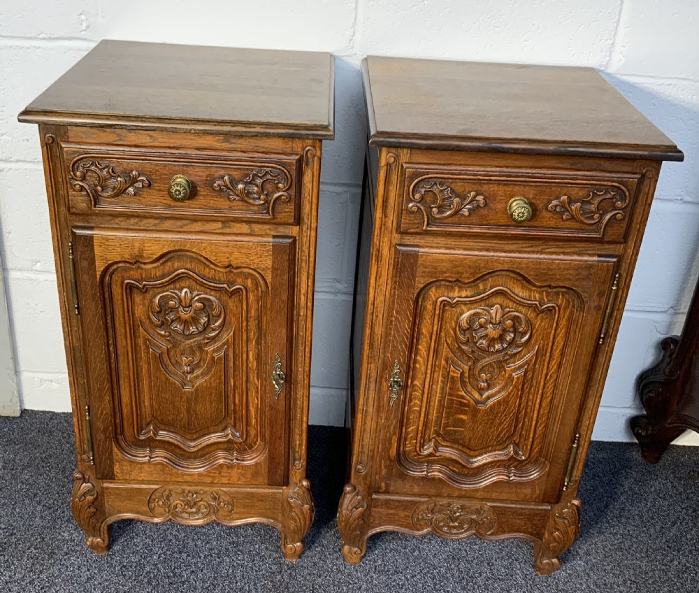 pair of oak carved bedside cabinets